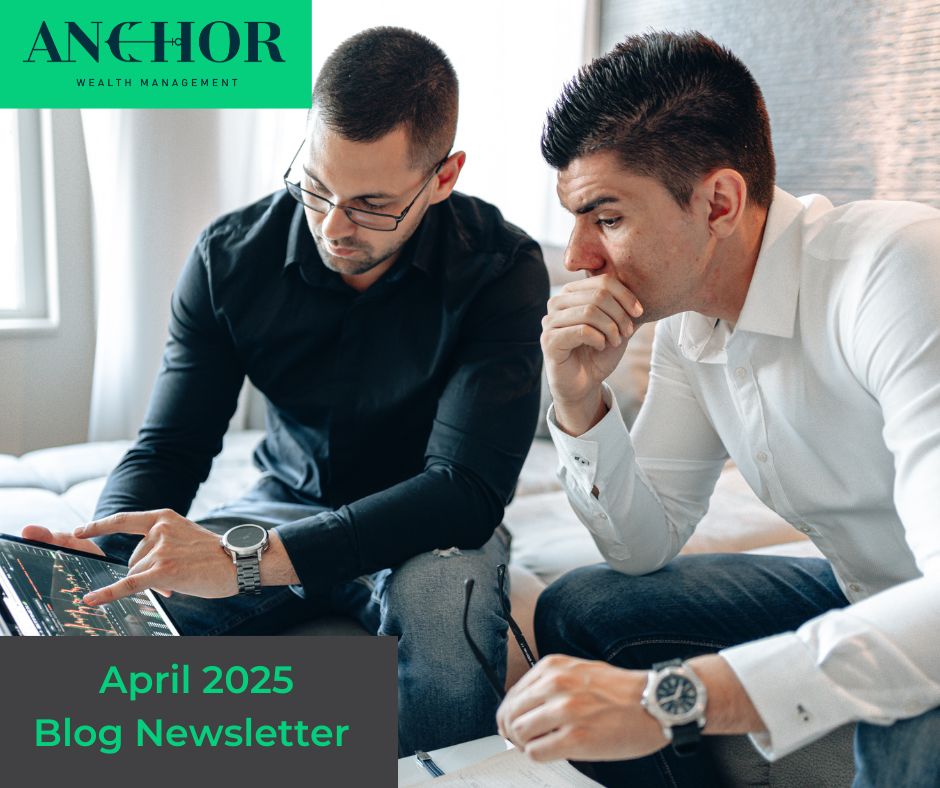 Two men talking while looking a laptop